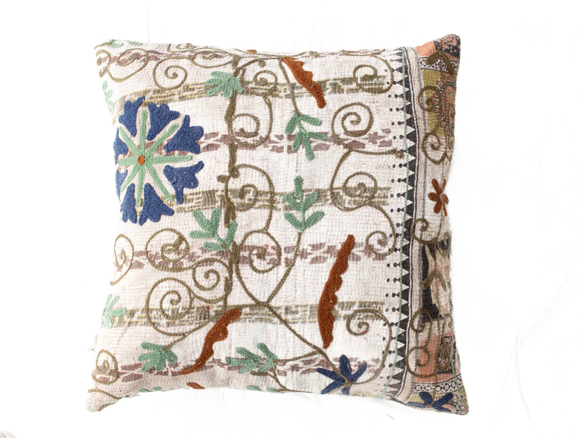 Suzani pillowcase 50x50 cm with colorful boho ethnic floral embroidery in blue green and brown on a white background with vintage wrap pattern and border.